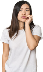 Young Chinese woman biting fingernails, nervous and very anxious.
