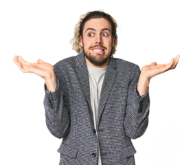 Young businessman in casual blazer confused and doubtful shrugging shoulders to hold a copy space.