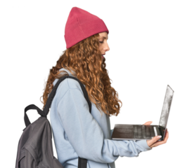 Redhead student working on laptop, studio setting