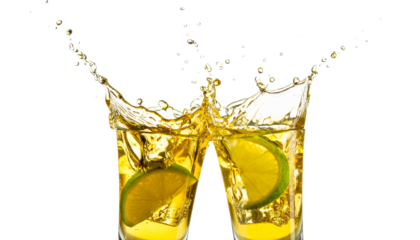Glasses shot of tequila making toast with splash isolated on solid white background in Png form