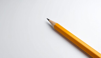 A classic yellow number two pencil with a sharp graphite tip resting on a blank white sheet of paper.