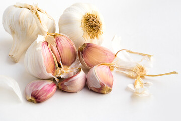 garlic heads and cloves on white background