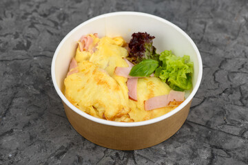 omelet with milk sausage and salad in a disposable dish