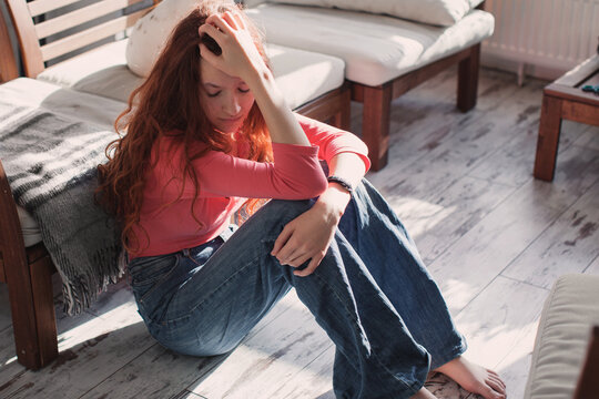 Sad depressed young adult woman crying alone at home, upset