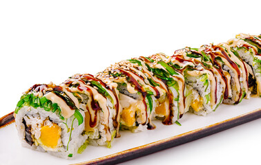 Delicious sushi roll with fresh ingredients and sauces on a white plate