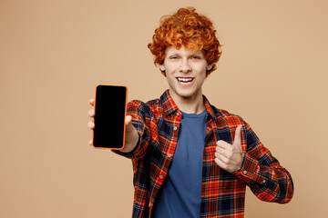 Young redhead man he wear red shirt blue t-shirt casual clothes hold in hand use blank screen area...