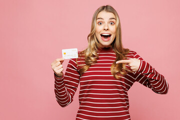 Young happy woman she wearing red striped sweatshirt casual clothes hold in hand point on mock up...