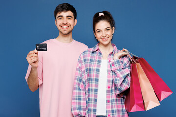 Young couple two friends family man woman wear pink casual clothes together holding credit card...
