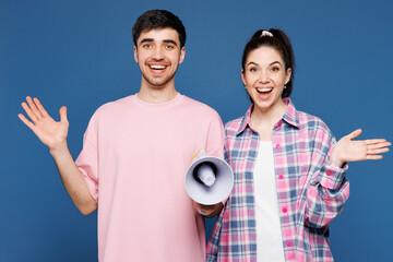 Young surprised couple two friends family man woman they wear pink casual clothes together hold...
