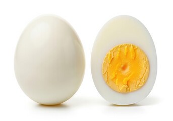 Whole and halved hard boiled egg on white background