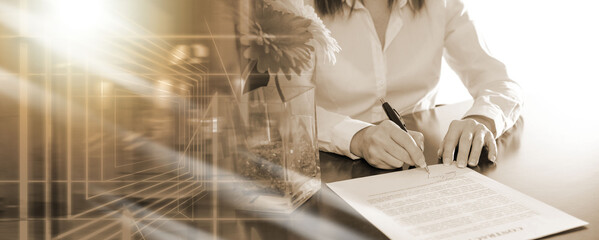 Businesswoman signing a document; multiple exposure