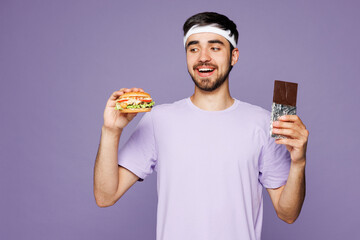 Young strong fitness trainer instructor sporty man sportsman wear headband t-shirt training in home...