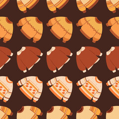 Seamless autumn pattern with knitted sweaters. Sweaters made of yarn, autumn clothing with knitted patterns. Vector ornament