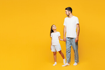 Full body young happy parent man with child girl wearing casual blue pyjamas clothes. Daddy little...