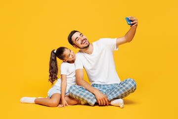 Full body young parent man with child girl wear casual blue pyjamas clothes. Daddy little kid do...