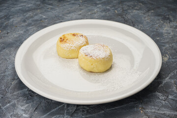 breakfast cheesecakes in a white plate on a gray background