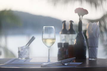 glass of cold white wine on the summer seashore by the water, relaxing by the water, a gentle...