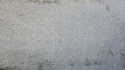 Old rough grey concrete wall with stains and uneven colors. Wall of a building, house, shop. Image...