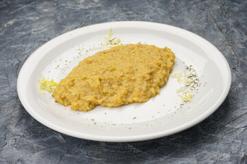 Wheat porridge seasoned with butter in a white plate on a background