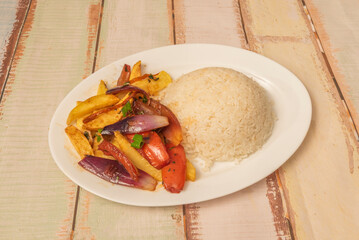 A refined version of lomo saltado with portobello mushrooms, panca chili, and red wine reduction, garnished with microgreens.