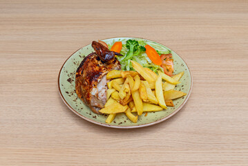 Peruvian-style grilled chicken with aji panca, accompanied by golden fries and red onion salsa criolla