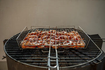 Fresh shrimps grilling on a barbecue, resting on a metallic grid over hot coals, releasing fragrant smoke and filling the air with a mouthwatering aroma, perfect for summer gatherings