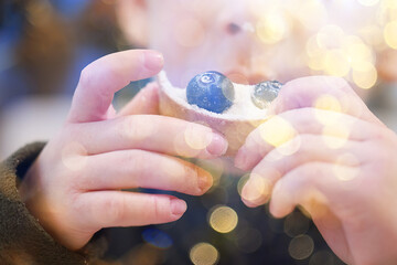 A 4-6-year-old boy eats a cake or candy close-up, a child eats sweets