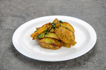 fried baked potato slices with spices