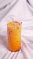 Iced thai tea isolated from white background. Perfect for recipe, article, catalogue, promotion, or...