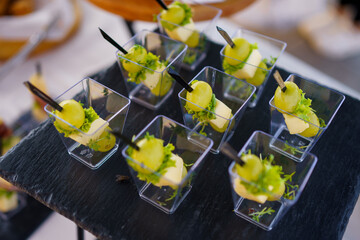 Refreshing cucumber appetizers served in clear cups during a summer outdoor event at a garden venue