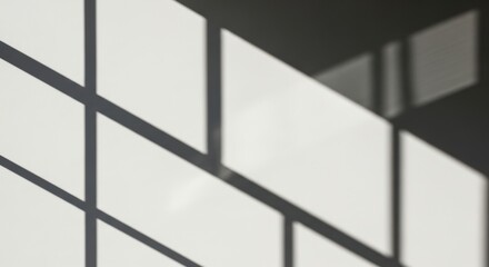 Geometric window frame shadow cast on a white wall background