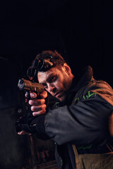 A young man with intense focus aims a weapon in a dark, dystopian setting.