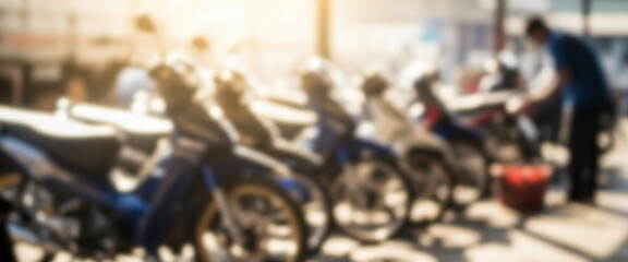 Fototapeta premium Row of motorcycles parked with a person working near them outdoors, reflecting everyday street scene, authentic culture of motorbike use, and community activity in an open environment.
