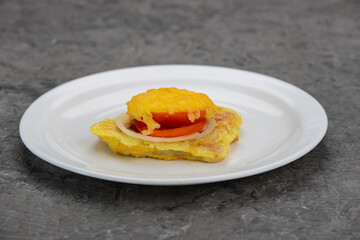 chicken chop with tomato and cheese on a white plate