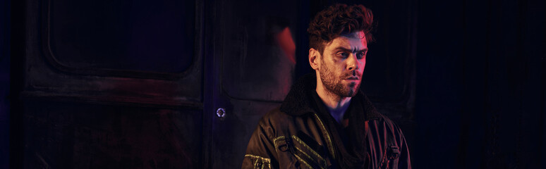 Determined young man stands amidst the ruins of a post apocalyptic landscape, embodying resilience.