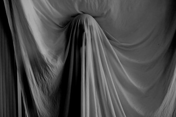 silhouette of a person against the background of a white sheet, the effect of a statue or a ghost