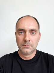 Obraz premium Portrait of a man in a black T-shirt on a white background