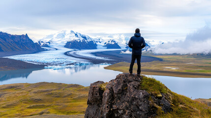 Obraz premium Breathtaking view of person standing rocky outcrop, overlooking vast glacier and serene lake surrounded by mountains. scene captures beauty
