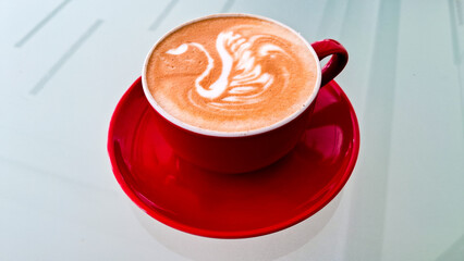 Cup of hot coffee with swan latte art