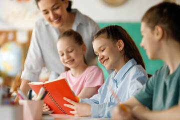 Happy kids and teacher at school
