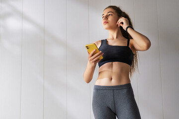 Woman in fashionable sportswear is doing exercise.