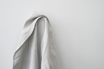 Light gray linen fabric draped on a wall