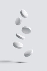 White pills levitating against a light gray background