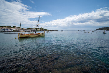 View of the crystal-clear waters of the Costa Brava with a boat in the landscape