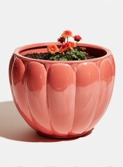 Coral-colored, ribbed planter with flowers
