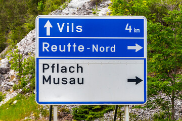 Blue road sign with location information direction and arrow Austria.