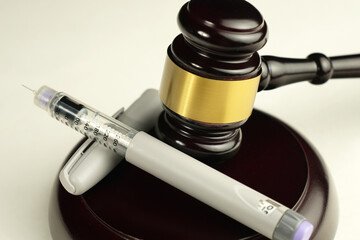 Semaglutide Syringe with Judge’s Gavel.  Medical Regulation and Legal Issues