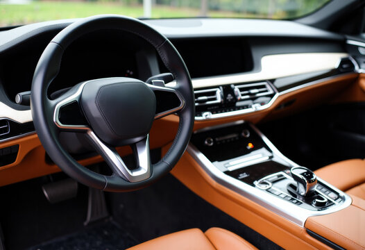 Luxury car interior with modern dashboard and steering wheel design