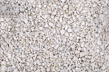 This image shows a close-up view of a surface covered with small irregularly shaped rocks or pebbles