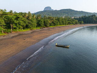 Wide aerial view of São João dos Angolares beach in São Tomé, with golden sand, calm turquoise...